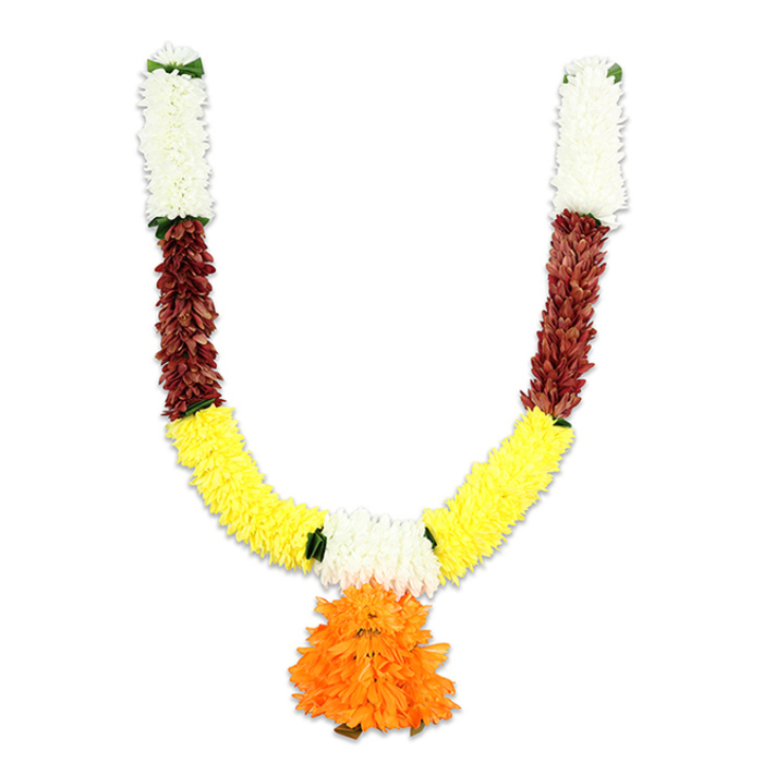 Framed against a plain white field, this traditional U-shaped artificial mala is a study in layered colour and festive texture, the sort of heirloom-style decoration you might see at a wedding arch or hanging over a puja altar in Stanmore. Each upper arm begins with a dense, vertical robe of creamy white blooms-plush, chrysanthemum-like clusters that reflect soft light and lend the garland a serene top-weight. Immediately below, a striking strip of reddish-brown follows: tightly packed, textural components that read like dried petals or sculpted fabric, their warm, mahogany undertone adding grounding contrast. The curve of the garland opens into a broad band of bright, cheerful yellow; these marigold-reminiscent pom-poms are arranged densely to create a lush, continuous lower arc that feels celebratory and abundant. Intermittent flashes of bright green-small leaf accents or neat ribbon ties-break the colour fields with a fresh, botanical note.
At the very centre hangs a substantial orange tassel-like pendant, layered with ruffled petals that form a round, exuberant focal point. The piece appears soft to the touch yet deliberately robust, designed for repeated ceremonial use rather than ephemeral freshness. Under gentle studio lighting the colours glow with cultural resonance-white for purity, yellow and orange for auspiciousness-making this garland perfect for Diwali doorframes, Ganesh ceremonies, or welcoming guests to a marriage on a crisp afternoon near Stanmore Station. The craftsmanship suggests both practicality and devotion: an artificial garland that preserves the spirit of the festival while offering enduring beauty.