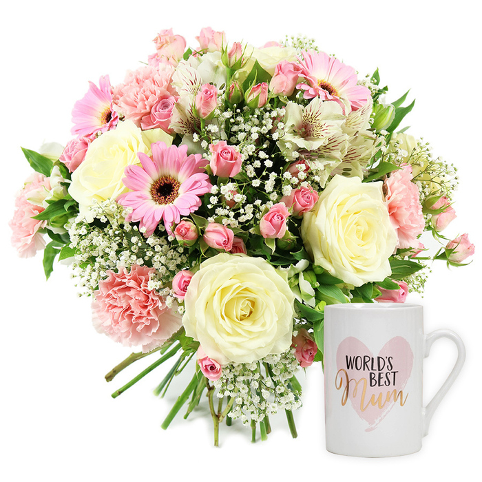 A beautifully styled, sentimental gift set is shown in a high-key studio photograph against a spotless white background, highlighting every detail of the flowers and the keepsake mug. On the left, a generous hand-tied bouquet forms a rounded, dome-like shape, its stems neatly gathered and exposed at the bottom. The colour palette is soft yet lively, blending creamy whites, blush tones, and stronger pinks with accents of fresh green. Several large cream or pale yellow roses anchor the design, their fully opened blooms revealing graceful spirals of petals. Around them, bright pink gerbera daisies with dark, almost chocolate-brown centres add a cheerful, contemporary touch, while ruffled light pink carnations contribute layered texture. Smaller, darker pink spray roses or rosebuds are dotted throughout the arrangement, making the bouquet appear full and abundant. Slender white alstroemeria blooms, each petal marked with delicate reddish-brown flecks, thread their way between the larger flowers, adding elegance and a slightly wild, garden-like feel. Fine sprays of white baby's breath hover between the blooms like soft mist, ensuring there are no harsh edges and enhancing the airy look. Glossy green foliage peeks out here and there, framing the flowers and reinforcing their freshness. To the right, a classic white ceramic mug stands upright, its surface smooth and reflective. A soft, watercolour-style pink heart decorates the front, enclosing the words World's Best Mum. The phrase World's Best appears in a simple, dark font above Mum, which is picked out in shimmering gold or coppery script, giving a gentle glint under the lights. The overall composition feels like a polished product shot from Flower Delivery Stanmore, ideal for a Mother's Day surprise or thank you gift to a beloved mum living near Stanmore Hill or close to Bentley Priory Nature Reserve.