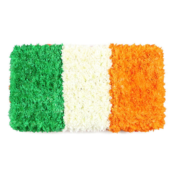 An elegant, hand-tied interpretation of the Irish Tricolour, this rectangular floral banner sits against a pristine white backdrop, its three vertical stripes created entirely from densely packed petals. The emerald left panel is a lush field of tiny green blooms-perhaps chrysanthemums or carnations-whose minute blossoms form a soft, veined texture that suggests a living carpet. The central stripe of white petals appears soft and airy, while the right-hand orange panel glows with warm sunshine, built from countless tiny blossoms that echo the texture of its neighbours. The entire banner preserves the flag's proportional rhythm, a mindful balance of colour and form that can be admired up close or from a distance.
The symbolism runs deep here: unity through difference, peace as a shared longing, and heritage carried in every petal. The white background elevates the colours, giving the piece an almost luminescent clarity-perfect for cultural features, St Patrick's Day features, or remembrance articles about Irish identity in Ireland and Britain alike. In Stanmore, this kind of crafted floral piece is cherished for events at the community hall, local churches, and spring markets nearby Canons Park. Flower Delivery Stanmore offers similar works with dependable, same-day delivery across Stanmore and surrounding NW London locales, bringing a handcrafted statement of pride and belonging into homes and gathering spaces.