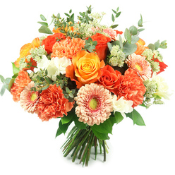 Bathed in clean, natural light against a stark white background, this hand-tied bouquet reads like a captured moment of sunshine - a dense, rounded composition of warm oranges, peachy corals, creamy ivory and fresh green accents. At its heart are several prominent roses, some in deep tangerine and others in a soft golden-yellow, their petals unfurling in tight, elegant spirals that draw the eye inward. Between them, multi-layered carnations in coral and burnt-orange add soft, textural fullness with their ruffled petals, while peach-toned gerbera daisies open like small suns with greenish-yellow centres that add a playful contrast. Small white spray blooms, reminiscent of freesia, breathe light into the arrangement and lift the warmer tones, while airy clusters of pale green, astrantia-like filler add a delicate, almost lacey texture. Silvery-green eucalyptus leaves are woven through the mass, their round, muted foliage adding coolness, fragrance and a subtle architectural line that frames the blooms.

The stems are gathered and tied in a neat, hand-tied finish, ready for a vase or same-day delivery across Stanmore. As a florist with Flower Delivery Stanmore I lean on this palette for celebratory orders - birthdays, thank-yous, or a cheerful anniversary bouquet that feels both elegant and heartfelt. I imagine it travelling from Stanmore Station to a home near Canons Park, filling a table with warmth, the rose's heady sweetness balanced by the eucalyptus's crisp, green notes. The overall effect is joyful and refined, suitable for seasonal displays in spring, summer or the softer tones of early autumn.