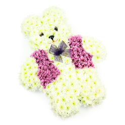 A tender teddy bear floral tribute is the sole focus of this photograph, framed by a spotless white background that emphasises every shape and shadow. The bear is lovingly constructed from creamy white chrysanthemums, placed so densely that they mask the underlying structure and create a plush, velvety surface. The head is softly rounded with small ears defined by subtle curves of petals, while the body forms a solid, reassuring shape with compact arms and legs that appear to rest gently in front. Dark, bead-like floral elements form the eyes, looking forward with a calm, comforting gaze, and a tiny dark nose sits centrally between them. Below, the faint outline of a smile gives the impression of gentle kindness, like a favourite toy kept close for reassurance. Draped across the front is a vest-style pattern of deeper pink, mauve, and lilac blooms, likely a combination of hydrangea clusters and tinted chrysanthemums, their colours forming two neat panels that meet at the centre of the chest. At the neck, a delicate bow in sheer purple netting is tied into a small, tidy knot, its airy texture contrasting with the dense cushion of petals below. The lighting is soft and diffuse, highlighting the freshness and subtle sheen of the flowers. In Stanmore and surrounding areas such as Canons Park and Belmont, arrangements like this are often selected for children's funerals, memorials, or baby farewells, adding a touch of innocence and tenderness to services at local crematoria. It is the kind of piece that Flower Delivery Stanmore would carefully prepare and hand-deliver, offering solace through a familiar, comforting shape rendered in living blooms.