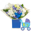 A soft, lullaby-like arrangement captured against a clean white backdrop: a round, generous bouquet resting in a matte royal blue rectangular gift box, designed to celebrate the arrival of a baby boy. At the heart sit creamy white roses and partially unfurled white lilies whose delicate buds promise new beginnings; their gentle scent is imagined as a quiet, green floral hush. Full, fluffy white chrysanthemums create a pillowy base while vivid electric blue chrysanthemums punctuate the composition with joyful, almost playful pops of colour. Interspersed among them are clusters of pale lavender, hyacinth-like florets and smaller periwinkle blooms that add a layered texture, their bell shapes leaning into the light. Lush green foliage-broad glossy leaves and feathery fern fronds-frames the bouquet and gives depth, the leaves catching soft highlights across their veins. The stems are gathered and swathed in crinkled, translucent cream paper, the tactile pleats folded around the base and tucked into the blue box for a refined presentation. To the right, a light blue foil balloon in the shape of a vintage baby carriage floats with a slight sheen; darker blue accents on the canopy and wheels are dotted with tiny hearts, and the phrase It's a Boy arches across the carriage in cheerful yellow and lime green lettering. The overall feeling is intimate and celebratory-a comforting, well-crafted welcome gift for a newborn son that would feel perfectly at home being delivered to a new family in Stanmore, perhaps to a parent returning from Northwick Park Hospital or celebrating at home near Stanmore Common.