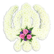 A beautifully composed Sikh Khanda floral tribute dominates the frame, photographed against an immaculate white background that allows its symbolic shape to be seen with clarity. The entire emblem is formed from dense clusters of white chrysanthemums, each blossom pressed snugly into place so that the Khanda appears soft yet solid, like a sculpture carved from petals. The central double-edged sword extends vertically, held within the circle of the chakkar, while the two kirpans curve outward in graceful arcs, all outlined through the steady repetition of creamy white flowers. At the base, where the blades meet, a small but striking accent arrangement introduces colour and emotional nuance. Three pink roses, gently opening, are surrounded by rich purple flowers and finely textured green ferns, their hues standing out against the serene white foundation. The roses' delicate spirals and the velvety purple tones add a sense of intimacy, hinting at personal memories and heartfelt messages that might accompany the tribute. Soft, even lighting ensures that every petal and frond is visible, yet nothing distracts from the overall tranquillity of the scene. With no additional décor or background detail, the focus rests entirely on this floral Khanda, making it easy to imagine it displayed at a Sikh funeral or memorial service in Stanmore, perhaps in a quiet hall or near a simple altar. Crafted with precision and respect by a local Stanmore florist, the arrangement conveys peace, spiritual devotion, and a tender farewell offered through the language of flowers.