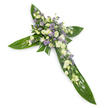 A solemn, elegant floral cross pictured against a clean white backdrop and viewed from a soft overhead angle, this tribute rests like a quiet offering rendered in blooms and glossy green. The structure is formed from broad, tropical leaves-think Ti or similar waxy green foliage-with visible veins and a reflective surface that creates a sculpted, verdant cruciform. At the intersection and running along each arm there is a dense, lovingly arranged carpet of flowers in a tranquil palette of soft white, creamy ivory and pale lavender-purple. Ruffled lisianthus in gentle ivory and white provide the principal form, their layered petals folding outward like quiet prayers, while small white chrysanthemum-type blooms and miniature spray roses add tight, luminous points of texture. Interspersed through these are sprays of tiny, starry lavender accents-limonium or small asters-that drift like a whisper of colour and lend delicate depth. Finer green fillers are threaded through the clusters, softening edges and enhancing the living feel. The even, neutral lighting highlights the contrast between the smooth, glossy leaves and the feathery softness of the flowers, producing a calm, contemplative radiance. Scent is barely perceptible: a faint, green freshness with a hint of powdery florals. This composition reads as a traditional sympathy piece meant for funerals, memorials or church services, offering comfort and reverence. Locally, families in Stanmore often choose this style for services at small chapels near Stanmore Broadway or moments of quiet remembrance beside Bentley Priory, where the colours and shape convey hope and enduring peace.