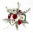 This brilliant bouquet, captured in gentle daylight, is a feast for the senses-a graceful fusion of red, white, and soft lilac, lovingly arranged by Stanmore's local florists with an eye for both tradition and whimsy. Lush red roses, reminiscent of cherished moments in Canons Park, provide dramatic depth and romantic energy at the arrangement's center. Bright white gerbera daisies dance around them, their warm brown centers creating lively contrasts that catch the light. Soft billows of white spray chrysanthemums weave throughout, their feathery texture lending a gentle, celebratory air. Pale lilac lisianthus slip between larger blooms, offering serene notes that call to mind the pastel sunsets seen over Stanmore's skyline. Sprays of silvery-green eucalyptus stretch outward with casual grace, their rounded leaves imparting fresh fragrance and a contemporary finish. Wisps of slender foliage help shape a relaxed yet intentional composition, all illuminated by natural light for a vibrant, welcoming effect. Designed for intimate occasions or grand celebrations alike-birthdays, anniversaries, or simply sharing joy across Stanmore-this bouquet captures the heartfelt artistry and warm spirit that define the best of Stanmore's floristry.