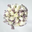 There is an easy, graceful beauty to this bouquet, capturing the tranquil essence of a quiet Stanmore morning. At its heart, pristine white roses unfold in tightly layered spirals-a vision of hope and renewal-while delicate sprays of lavender statice add a fine, lace-like texture reminiscent of light drifting across the spaces near Stanmore Hill. The bouquet is illuminated by soft daylight, letting the creamy tones of the roses glow gently against a whitewashed background that enhances their purity and freshness. Hints of fresh green emerge between the blooms, offering gentle movement and subtle vibrancy. Every nuance-every soft petal and downy statice cluster-tells of careful composition by a dedicated local florist. The effect is one of serene elegance and heartfelt sentiment, perfect for moments of sympathy, sincere congratulations, or simply to lend an air of calm celebration to a Stanmore home. The bouquet's subtle fragrance, paired with its visual harmony, creates a memory that lingers-delicate, comforting, and crafted with heartfelt expertise.