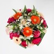 This vibrant Stanmore bouquet is a jubilant celebration of colour, texture, and local craftsmanship-a testament to marking life's happiest milestones. Orange gerberas, vivid and electric, create a focal point that gleams in the soft light much like early sunbeams over Stanmore's rolling fields. Rich magenta carnations and soft pink roses provide plush layers of indulgent texture, each petal velvety to the touch and bursting with vitality. Here and there, white alstroemeria and petite daisy clusters appear as gentle highlights, imparting a lift of freshness as if kissed by morning dew at Canons Park. The surrounding greenery is abundant yet disciplined, offering a rich, glossy framework that mirrors Stanmore's natural scenery. Every carefully selected bloom balances vibrant energy with refined beauty, resulting in a harmonious blend that feels as welcoming as it is artistic. Ideal for jubilant celebrations or heartfelt gifts, this bouquet brings together visual extravagance and a tender fragrance, echoing the community spirit of Stanmore and adding a breath of elegance to any occasion.