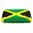 A bold Jamaican flag tribute is recreated as a three-dimensional rectangular panel, made up of innumerable small, ruffled fabric pieces that mimic the softness and density of a floral cushion. Floating against a bright white background, the design is instantly recognisable: a glowing golden yellow saltire extends diagonally from corner to corner, forming a strong X that divides the flag into four triangular fields. The top and bottom sections are filled with a lush, saturated green, their textured surface evoking the feel of a freshly tended lawn or the leafy calm of Stanmore's residential gardens. On either side, deep black triangles add solemn depth, their velvety, matte surface exuding a quiet dignity that seems tailor-made for funerals and remembrance services in local churches or crematoriums. The tactile quality is striking-every tiny fold and crumple of fabric casts minute shadows, giving the impression of movement and life, as though the tribute has been assembled petal by petal. Under bright, even lighting, there are no harsh reflections, only a gentle play of light and shade that enhances the vivid contrast between green, gold, and black. The rectangular block appears sturdy and substantial, suggesting it could be carried in procession or placed with care at the foot of a coffin during a service in Stanmore or nearby Bushey. Crafted with the same precision and heart that Flower Delivery Stanmore brings to its funeral designs, this piece stands as a powerful symbol of Jamaican pride, memory, and enduring love, providing families with a meaningful way to honour a life and its cultural roots.