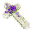 A dignified Christian cross floral tribute is shown laid upon a brilliant white background, its carefully arranged flowers suggesting the kind of respectful farewell often chosen for services in and around Stanmore. The structure of the cross is completely covered in tightly clustered white spray chrysanthemums, creating a smooth, padded appearance that feels soft and comforting. Each individual bloom features a tiny, pale-green centre that gently breaks up the white expanse and adds a touch of natural vibrancy. The outer edge of the cross is neatly finished with a slim lime-green ribbon, framing the piece with a tidy, contemporary border that highlights its contours. At the centre where the arms cross, a dramatic cluster of deep purple lisianthus commands attention. These velvety, multi-petalled blossoms range from fully open flowers to partially closed buds, creating depth and visual richness. Delicate fronds of greenery and small filler flowers weave around the lisianthus, softening the edges of the spray. From this central focal point, several lisianthus stems extend along the lower section of the cross, forming a diagonal trail of purple blooms that appears to gently cascade downward. The lighting is soft and even, with a faint shadow beneath the arrangement to provide a sense of dimension, as if the cross has just been placed on a stand ready for the service. Overall, the piece radiates calm, faith, and heartfelt condolence, making it a meaningful choice for honouring a loved one's memory in the Stanmore community.