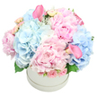 This pastel symphony glows softly in a pristine white hatbox, a refined fusion of velvety peonies, delicate spray roses, and airy hydrangeas that seems to shimmer in the gentlest morning light. The dominant pink peonies hold a theatre of petals-lush, multi-layered, and inviting-while the pale blue hydrangeas spread like a cool, clouded sky, giving the arrangement height and breath. Sprigs of blush spray roses peek through, their small, swirled buds adding texture and a whisper of romance, and two calla lilies in a deeper pink rise with sculptural grace, one tucked near the top-left and the other balancing toward the bottom-right. A hint of green-soft hydrangea leaves and a touch of dusty miller-traces the edges, providing subtle contrast and a natural, garden-fresh feel. The hatbox itself offers a clean, contemporary frame, letting the blooms sing with clarity against the white backdrop.
There is a sweet, almost nostalgic fragrance that lingers in the air, a reminder of spring mornings and long conversations in Stanmore's parks. As a gift, it speaks of quiet celebration and heartfelt care, suitable for birthdays, anniversaries, newborns, or gender reveals, and a refined centerpiece for a dining table or mantel. Crafted by a local Stanmore florist, this piece carries the care and discipline of someone who understands colour, texture, and proportion, with dependable delivery across Stanmore and nearby streets.
Delivered with a quiet confidence by a Stanmore florist who understands how to balance scale, color, and scent, it arrives ready to transform a room and to honour a special moment.