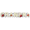 In this detailed floral tribute, the word GRANDMA stretches horizontally across the image in large, blocky capital letters, each one standing distinct yet connected as a single message of love. The letters are entirely composed of closely packed white cushion chrysanthemums, whose rounded blossoms and many fine petals give a full, soft texture, like a padded blanket of white. Peeking out from behind the flowers is a narrow trim of pale lavender or light purple ribbon, carefully following the outline of each letter and adding a quiet, graceful touch of colour that softens the overall design. Bright red accents have been thoughtfully placed to punctuate the tribute: the letter G is embellished with a lush group of deep red roses and a striking red-and-white variegated calla lily; the first A is marked with a single, heart-shaped red anthurium near its base, the shiny, sculpted bloom symbolising affection. At the centre, the M carries another cluster of velvety red roses and a second red anthurium, while the final A is finished with its own solitary anthurium, creating a gentle echo of red from one end of the tribute to the other. Beneath the flowers, a low dark green support frame holds the letters upright, much like those used for funeral flower deliveries to Stanmore's churches and crematoria or for a final journey along the quiet residential roads near Stanmore Hill. The arrangement feels both personal and dignified, an elegant way to say goodbye to a grandmother with flowers that speak softly of love, gratitude, and remembrance.