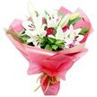 In this photograph, a richly detailed bouquet is captured against a spotless white background, making it easy to appreciate each flower as if you were standing at the counter of Flower Delivery Stanmore. Dominating the arrangement are white Oriental lilies, their large, trumpet-shaped blooms opening wide with a serene elegance. The petals are smooth and slightly arched, overlapping gently to form generous, star-like flowers whose centres are punctuated by striking stamens tipped with dark brown to nearly black anthers. Among these open flowers sit several lily buds, elongated and firm, in creamy tones tinged with soft green, their closed petals pressed tightly together in anticipation of future blossoms. Tucked between the lilies are deep red roses, mostly in tight buds or just unfurling at the edges. Their compact, velvety heads introduce a sense of warmth and romance, the intense red creating a beautiful visual dialogue with the pure white lilies. Framing this floral mix is an abundance of foliage: broad, glossy leaves provide a deep green backdrop, while slender, grass-like strands reach and curl, suggesting natural movement as if caught in a gentle Stanmore breeze. The bouquet is wrapped generously in bright pink, glossy cellophane that gathers into soft, crinkled folds around the stems. The semi-transparent material lets softened glimpses of stems and leaves show through, adding depth and a sense of layered colour. At the base, a narrow lime green satin ribbon is tied in a tidy bow or knot, its cool, fresh hue echoing the greenery and offering a playful contrast to the vivid pink wrapping. The entire arrangement feels joyful, polished, and heartfelt-a bouquet perfectly suited to local deliveries in Stanmore for birthdays, anniversaries, Mother's Day, or simply to bring a burst of beauty and affection into someone's day.