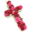 Set against a bright white backdrop, this traditional Christian cross made from fresh flowers appears as a serene and dignified funeral arrangement. The cross is fully enrobed in roses, their dense placement creating a sumptuous, almost fabric-like texture. Large, open deep red roses form the bulk of the design, their velvety petals and rich crimson hue evoking devotion, gratitude, and solemn remembrance. Blended harmoniously among them are clusters of fuchsia pink garden roses, whose softly ruffled petals and slightly lighter tone add a gentle, uplifting note, reminiscent of soft evening light over the rooftops of Stanmore. Smaller rosebuds in coordinating reds and pinks peek through the mass of larger blooms, adding dimension and the suggestion of memories that continue to blossom in the hearts of loved ones. The entire cross is edged with a delicate border of tiny white flowers-most likely spray chrysanthemums or similar filler blossoms-creating a clean, defined outline and a faint halo effect around the sacred shape. These white blooms bring a sense of purity, peace, and quiet hope to the arrangement. Subtle touches of green foliage and perhaps slim ribbons appear at the outer edges, giving a fresh, polished frame that subtly recalls Stanmore's tree-lined roads and nearby open spaces. Soft, even lighting highlights the contrast between the dark reds, vivid pinks, crisp whites, and soothing greens, making every petal and leaf clearly visible. This floral cross feels thoughtfully crafted for use at a funeral service, crematorium, church, or graveside ceremony in the Stanmore area, offering a graceful way to honour a loved one's faith, life, and enduring presence in family memories.
