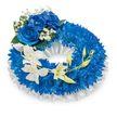 A circular memorial wreath arranged in serene shades of royal blue and ivory, photographed against a crisp white background. The ring is densely clothed with deep blue chrysanthemum heads - their fine, needle-like petals packed tightly to create a velvety, cushiony texture and a full, sculpted silhouette. Along the inner rim a soft, ruffled white satin ribbon is pleated beneath the flowers, its gentle sheen catching the light and offering a quiet, refined contrast to the saturated blue. At the upper-left quadrant three large blue roses sit as a small, regal cluster; their plush, layered petals open in a sapphire bloom and are framed by tiny cloud-like sprays of white gypsophila and speckles of dark green foliage for depth. From the mid-left the eye follows a sinuous cascade of pristine white orchids-Phalaenopsis-like blooms with broad, delicate petals-sweeping down toward the lower right, the arching stems suggesting movement and calm. Intermingled among the orchids are pale green buds in varying stages of opening, a gentle symbol of continuity amid remembrance. The overall impression is one of dignified sympathy: the cool blue tones convey peace and memory while the pure whites speak of purity and solace. The composition feels crafted by a careful hand, lit softly so textures read clearly - the satin's sheen, the chrysanthemums' plush density, the orchids' satiny translucence - making this wreath an understated, tender tribute suitable for a funeral service, graveside remembrance, or a quiet commemoration in Stanmore.