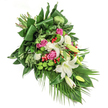 A tender and refined funeral spray inspired by Stanmore's tranquil surroundings, this cascade features an array of white, pink, and green blossoms flowing diagonally across a snowy white canvas. At its heart, majestic white lilies exude serenity-some blossoms open fully, their golden centres glowing, while others remain wrapped in gentle promise, embodying remembrance and hope for families in and around Stanmore Village. Scattered throughout are plush fuchsia and deep pink roses, their petals softly unfurling against clusters of ruffled white spray carnations, which lend the bouquet a gentle softness like the scattered clouds above Stanmore. Bright lime-green santini chrysanthemums offer spheres of energetic life, their texture popping against the classic blooms. Here and there, vivid red hypericum berries gleam with cheerful brilliance, adding a sense of lightness to the arrangement's rich veins of glossy green foliage and delicate, feathered leaves. Trails of long, palm-like fronds sweep downward in a graceful cascade, evoking Stanmore's rolling green spaces and lending the piece a modern, natural elegance. Bathed in quiet, natural light, the composition glows with subtlety-an ideal choice for expressing sympathy or honouring a memory, bringing comfort and a sense of peace to gatherings throughout Stanmore.