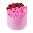In this image, a vibrant two-tone rose box radiates romance and modern luxury, crafted by a Stanmore-based florist for delivery across the area. The pastel pink hatbox is cylindrical, its velvet surface soft to the touch, and centered against a crisp white background that makes the colours pop. Inside, dozens of roses fill the space, their heads fully opened to display concentric circles of petals. The top portion forms a curved crescent of about twelve deep crimson red roses, a dramatic heart-shaped line that speaks of passion and devotion. The larger lower half brims with many vivid fuchsia pink roses, creating a playful, sunlit contrast that brings warmth to the composition. Each bloom appears pristine and perfectly arranged, with stems trimmed and foliage kept to the minimum so the surface remains smooth and luxurious. The overall effect is indulgent and celebratory, a gift box that signals thoughtful preparation for Valentine's Day, anniversaries, birthdays, or a special surprise. The scent is light and uplifting, and the visual harmony makes it a natural centerpiece for a dining table or a refined shelf display. For Stanmore locals, Flower Delivery Stanmore offers this elegant creation with reliable delivery across the area, turning any occasion into a memory. It is the kind of box that invites admiration, a keepsake bouquet designed to be enjoyed again and again.