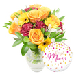 A warm, celebratory bouquet set against a clean white background, arranged in a simple clear glass vase that shows the crisp green stems and water beneath. The floral composition is a sunlit tapestry of warm tones: full, velvety roses in radiant orange and peach occupy the central eye, their petals unfurling in soft spirals, while bright yellow gerbera daisies punctuate the arrangement like small suns, each with a dark brown centre that gives a gentle graphic contrast. Deep maroon or burgundy carnations tuck between the larger blooms, their ruffled, plush petals adding shadowed texture and a sense of depth. Slender white alstroemeria petals, with faint speckling at their throats, lift the palette with delicate, airy grace. Glossy broad leaves and fine, feathery greenery cradle the flowers, creating a lush backdrop and framing the bouquet's warm energy. To the lower right, a round white foil balloon leans playfully against the vase, dotted with scattered gold and fuchsia polka-dots and tiny hearts; across its centre, best Mum is scripted in flowing hot-pink cursive, the message both intimate and celebratory. Imagine the scent: a soft, honeyed rose note with a faint green freshness from the foliage, perfect for a Mother's Day surprise or a birthday bouquet. The arrangement reads as thoughtful and expertly balanced, the clear vase and visible stems suggesting garden-fresh care. A local florist in Stanmore might send this to a neighbour on Stanmore High Street or deliver it to a home near Stanmore Park for a quietly joyful moment.
